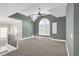 Spacious bonus room featuring vaulted ceilings, a fan, and a large arched window at 360 Wembley Cir, Atlanta, GA 30328