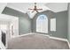 Bonus room featuring vaulted ceilings, a fan, and a large arched window at 360 Wembley Cir, Atlanta, GA 30328