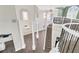 Grand foyer with soaring ceilings, decorative columns, and a curved staircase with wrought iron railings at 360 Wembley Cir, Atlanta, GA 30328
