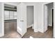 Hallway view featuring gray walls, wood-look floors, and white trim, connecting rooms with open doorways at 360 Wembley Cir, Atlanta, GA 30328