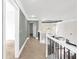 View of the upstairs hallway featuring gray walls, white crown molding, and black metal railing at 360 Wembley Cir, Atlanta, GA 30328