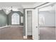 Bonus room featuring vaulted ceilings, a fan, a large arched window, and a walk-in closet at 360 Wembley Cir, Atlanta, GA 30328