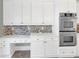 Modern kitchen with stainless steel appliances, white cabinets, and stylish backsplash at 360 Wembley Cir, Atlanta, GA 30328