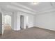 Spacious main bedroom with neutral carpet, tray ceiling, and ensuite bathroom at 360 Wembley Cir, Atlanta, GA 30328
