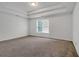 Bright main bedroom showcases neutral carpeting and a large window that provides plenty of natural light at 360 Wembley Cir, Atlanta, GA 30328