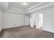 Spacious main bedroom features neutral carpeting, recessed lights, and an ensuite bathroom and walk-in closet at 360 Wembley Cir, Atlanta, GA 30328