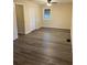 Bedroom showcasing wood-look floors, ceiling fan, closet and two windows at 3698 Fairlane Nw Dr, Atlanta, GA 30331