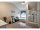 Bright bathroom with a tub under a window and a glass-enclosed shower at 506 Pleasant View Ct, Woodstock, GA 30188