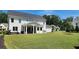 Expansive backyard with a covered patio area featuring outdoor dining and lounge furniture, ideal for relaxation at 2903 Eva Clb, Acworth, GA 30101