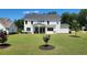 Spacious backyard featuring a well-maintained lawn and a covered patio, perfect for outdoor entertaining at 2903 Eva Clb, Acworth, GA 30101