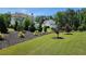 Lush backyard featuring meticulously manicured landscaping, small trees, and a well-maintained lawn at 2903 Eva Clb, Acworth, GA 30101