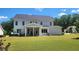 Spacious backyard with covered patio, hot tub, and well-manicured lawn, perfect for entertaining at 2903 Eva Clb, Acworth, GA 30101