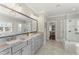 Bright bathroom featuring double vanity, oversized mirror, and walk-in shower at 2903 Eva Clb, Acworth, GA 30101