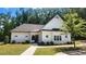 Exterior view of a well-maintained clubhouse featuring a white facade and manicured lawn at 2903 Eva Clb, Acworth, GA 30101