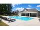 Community pool with deck chairs and picnic area surrounded by lush greenery at 2903 Eva Clb, Acworth, GA 30101