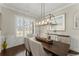 Bright dining room features natural light, modern chandelier, hardwood floors, and buffet table at 2903 Eva Clb, Acworth, GA 30101