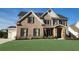 Lovely two-story brick home with well-maintained lawn and attached three car garage at 2903 Eva Clb, Acworth, GA 30101