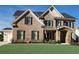 Charming two-story brick home with well-maintained lawn, black shutters, and stone-accented entrance at 2903 Eva Clb, Acworth, GA 30101