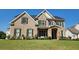 Inviting two-story home with a brick facade, complemented by a lush lawn and stone-accented entryway at 2903 Eva Clb, Acworth, GA 30101