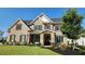 Desirable brick home featuring dark shutters, an arched stone entry, and a lush green lawn at 2903 Eva Clb, Acworth, GA 30101