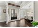 Welcoming foyer with dark hardwood floors, wood beam, and views to living and dining spaces at 2903 Eva Clb, Acworth, GA 30101