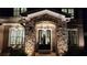 Elegant stone-accented doorway featuring double doors and decorative hanging lanterns provides curb appeal at 2903 Eva Clb, Acworth, GA 30101