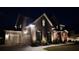 Charming home with a brick facade, well-lit landscaping, and a two-car garage at twilight at 2903 Eva Clb, Acworth, GA 30101