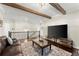 Upstairs loft area featuring a large TV, exposed beams, and comfortable leather seating at 2903 Eva Clb, Acworth, GA 30101