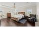Relaxing main bedroom featuring tray ceilings, hardwood floors, and ample natural light at 2903 Eva Clb, Acworth, GA 30101