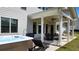 Relaxing patio area with a hot tub, lounge chair, and outdoor dining set, perfect for unwinding outdoors at 2903 Eva Clb, Acworth, GA 30101