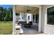 Cozy covered patio with ceiling fan, outdoor dining set, and manicured landscaping, ideal for outdoor gatherings at 2903 Eva Clb, Acworth, GA 30101