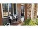 Cozy front porch with stone floor, bench seating, and decorative planters at 2903 Eva Clb, Acworth, GA 30101