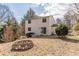 Spacious backyard with a fire pit, mature trees, and a sliding glass door entrance to the house at 3344 Creekwood Dr, Rex, GA 30273