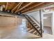 Unfinished basement with stairs and sliding door offers great potential for customization at 3344 Creekwood Dr, Rex, GA 30273