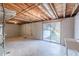 Unfinished basement with a sliding glass door offers great potential for customization at 3344 Creekwood Dr, Rex, GA 30273