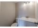 Powder room featuring a modern vanity with granite countertop, toilet, and updated lighting at 3344 Creekwood Dr, Rex, GA 30273