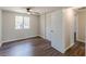 Bedroom with neutral walls, wood-look floors, a ceiling fan, closet, and a window with natural light at 3344 Creekwood Dr, Rex, GA 30273