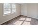 This bedroom features wood-look flooring, a double window and a closet with folding doors at 3344 Creekwood Dr, Rex, GA 30273