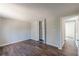 Bedroom features wood-look flooring, a closet with folding doors, and a hallway doorway at 3344 Creekwood Dr, Rex, GA 30273