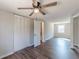 Bedroom featuring closet, wood-look floors, neutral walls, and a window with natural light at 3344 Creekwood Dr, Rex, GA 30273