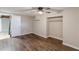 Newly renovated bedroom featuring ceiling fan, closet and modern vinyl flooring at 3344 Creekwood Dr, Rex, GA 30273