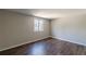 This bedroom has a large window and wood-look flooring at 3344 Creekwood Dr, Rex, GA 30273