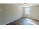 Neutral bedroom featuring a window and wood-look floors for a serene atmosphere at 3344 Creekwood Dr, Rex, GA 30273