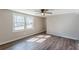 The bedroom has laminated wood flooring, neutral walls, and lots of light from the two windows at 3344 Creekwood Dr, Rex, GA 30273