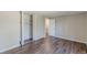 Bedroom features wood-look flooring, a closet with folding doors, and a hallway doorway at 3344 Creekwood Dr, Rex, GA 30273