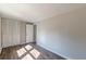 Bedroom with neutral walls, wood-look floors, and a closet for functional living at 3344 Creekwood Dr, Rex, GA 30273