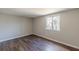 This bedroom has a large window and wood-look flooring at 3344 Creekwood Dr, Rex, GA 30273