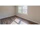 This bedroom features wood-look flooring and a double window at 3344 Creekwood Dr, Rex, GA 30273