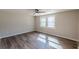 This light and airy bedroom has laminated wood flooring and two windows at 3344 Creekwood Dr, Rex, GA 30273