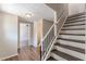 Entryway with staircase and view into the living room with wood-look flooring at 3344 Creekwood Dr, Rex, GA 30273